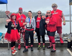People in Hot Tamales candy themed costumes with a lake in the background.