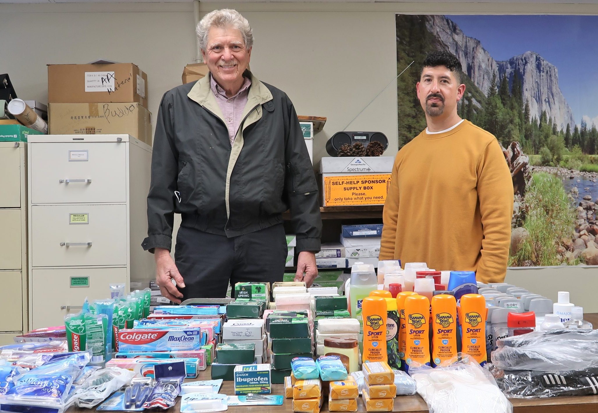 Two people with personal hygiene items to donate to the homeless population.