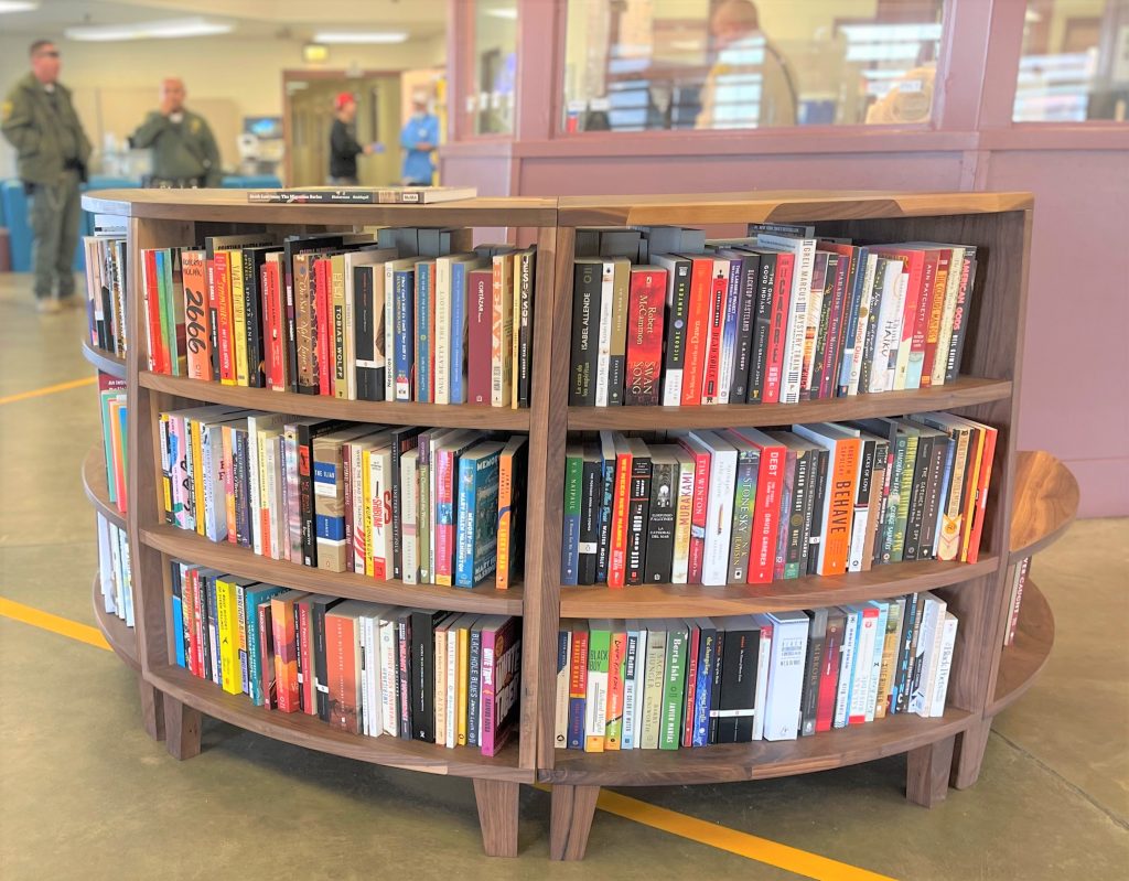 A circular bookcase full of colorful books.