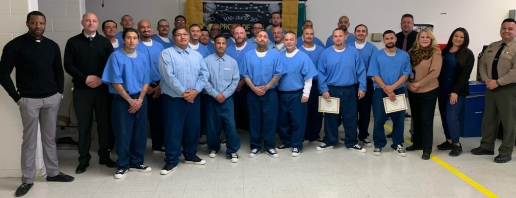 Prison staff and incarcerated program graduates. 