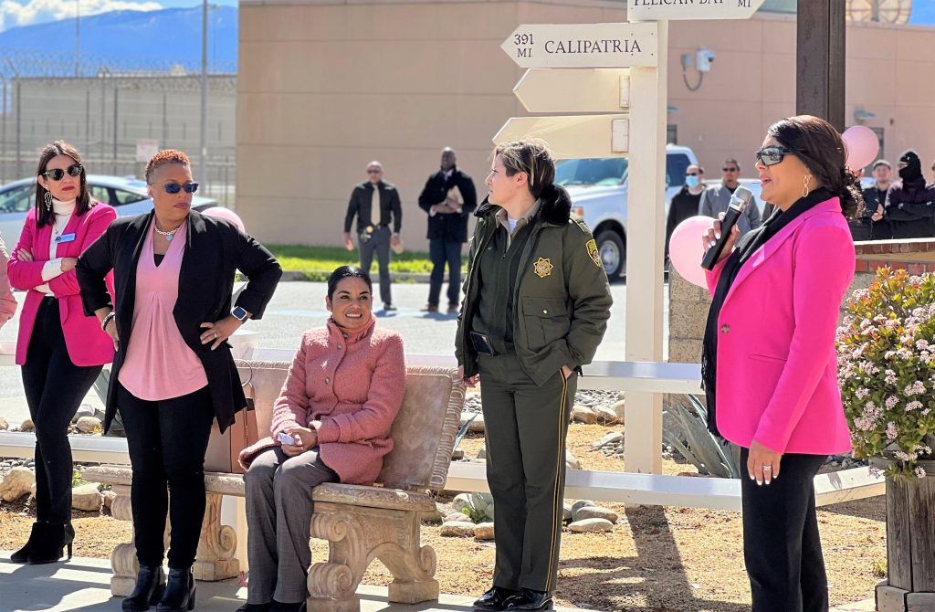 Women's History Month event at Salinas Valley State Prison with women listening to another one speak.