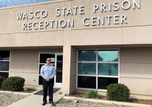 Wasco State Prison-Reception Center building with Eduardo Zamora standing in front.