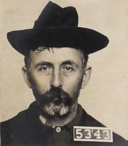 Man wearing hat with inmate number 5343 in 1903.