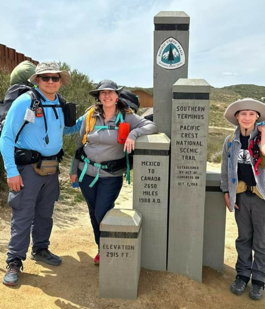 A father, mother and their son at the Pacific Crest Trail Southern Terminus