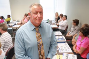 A correctional captain sits in a CPR training class.