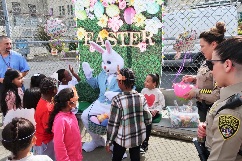 Easter Bunny and children in Folsom State Prison during special event.