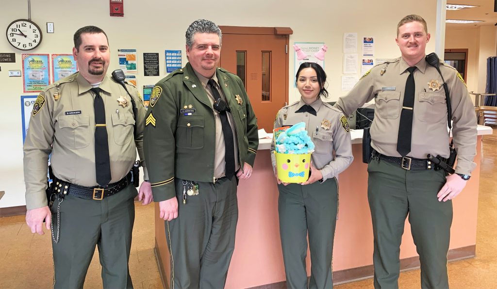 Four prison visiting staff members and an Easter basket.