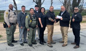 Salinas Valley State Prison Warden Allen presents donation of over $1k to Monterey County Chairman Tony Virrueta for Veterans Day Parade