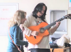 Two Incendio band members perform inside Avenal prison.