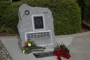 Monument marker at Wasco State Prison with names on it.