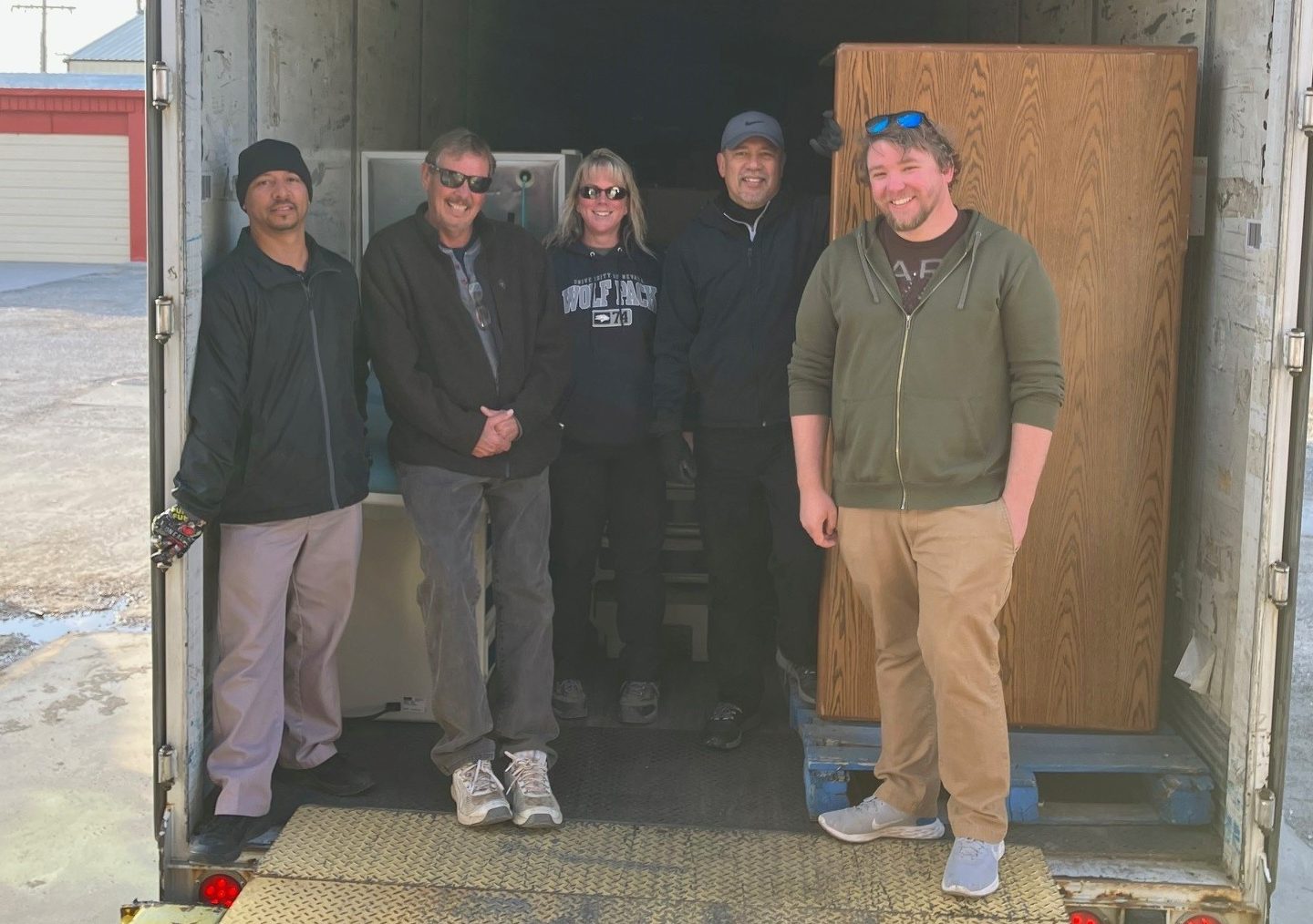 CCC staff stand in trailer