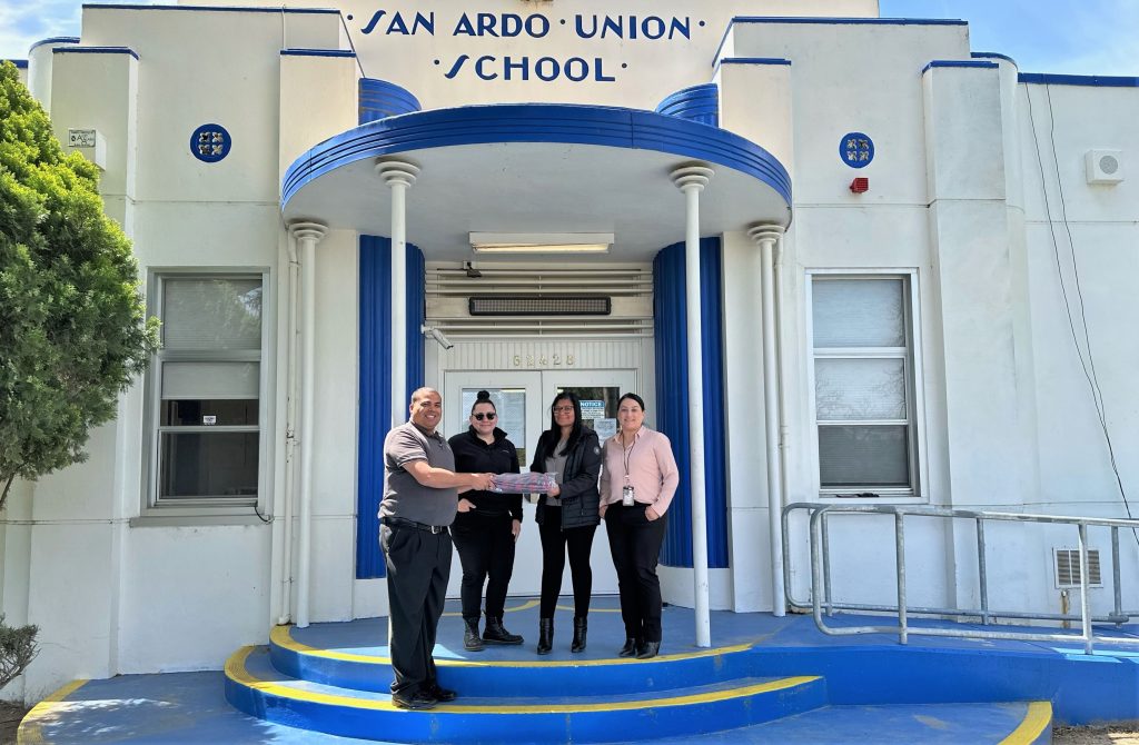 Prison staff present a donation to San Ardo Union School District.