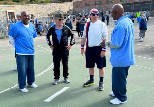 SQ staff standing with incarcerated for pickleball