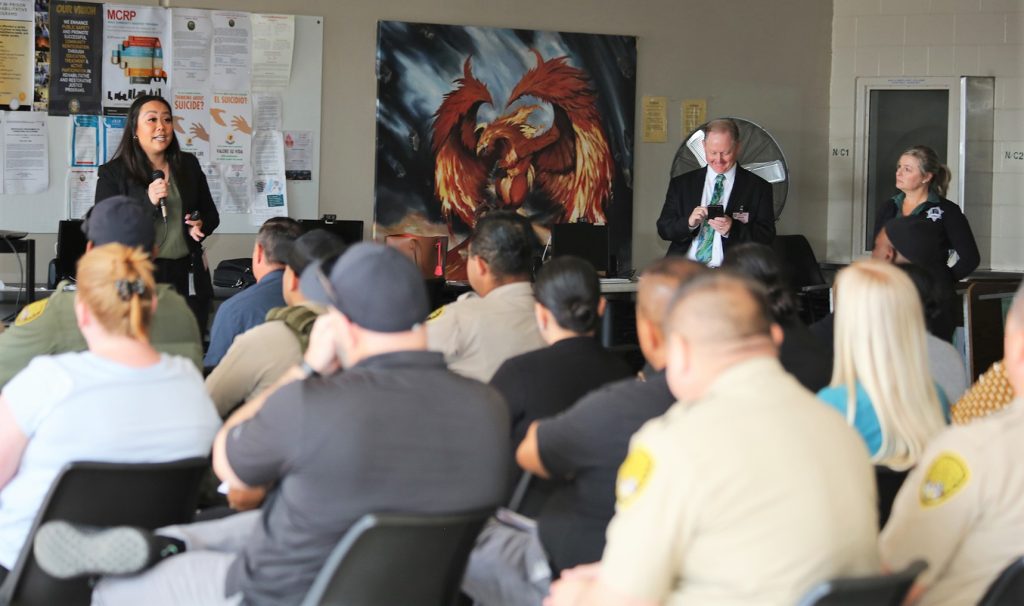 Prison staff listen during a National Crime Victims' Rights Week event.