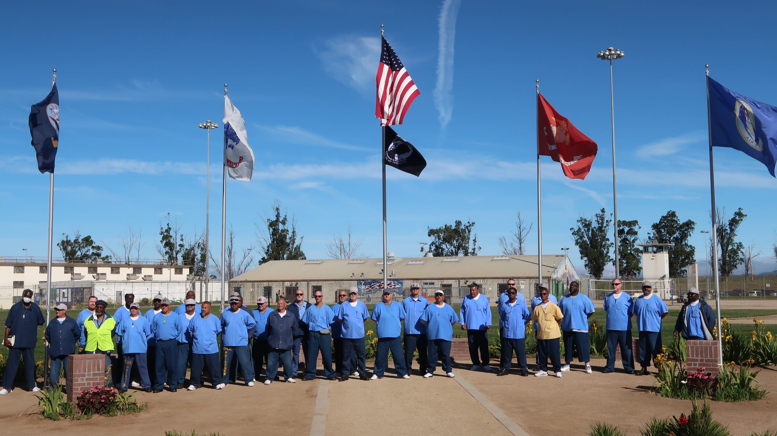 Incarcerated veteran s with flags at Correctional Training Facility (CTF) as part of Compassion Prison Project.