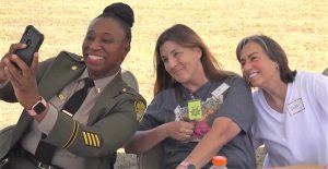 Correctional lieutenant and a volunteer with an incarcerated person having lunch at Central California Women's Facility.