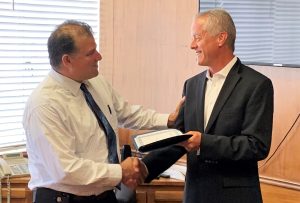 CMF acting warden shaking hands with Vacaville mayor.