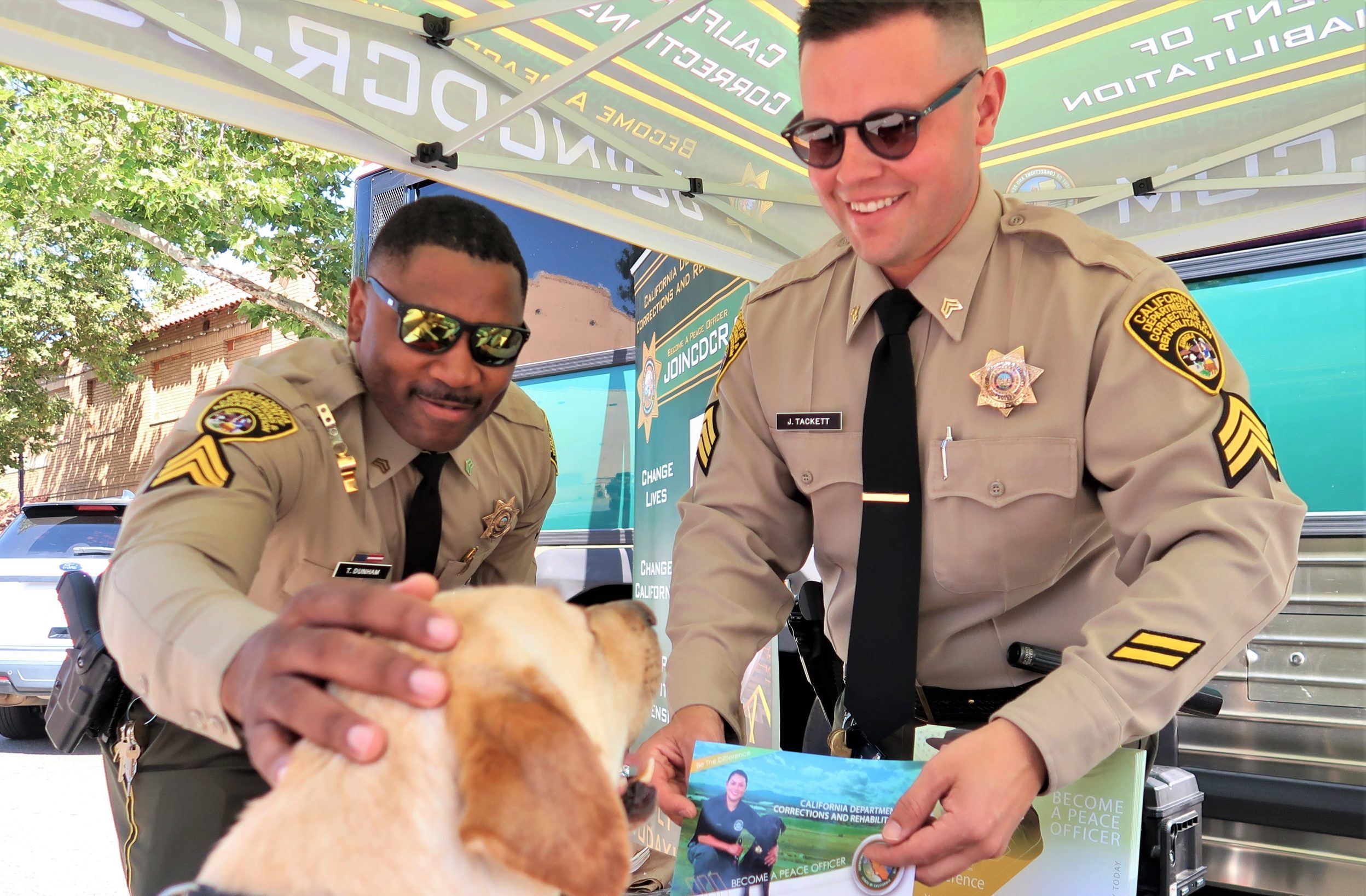 Two CDCR correctional sergeants and a dog at a market and safety event in Galt.