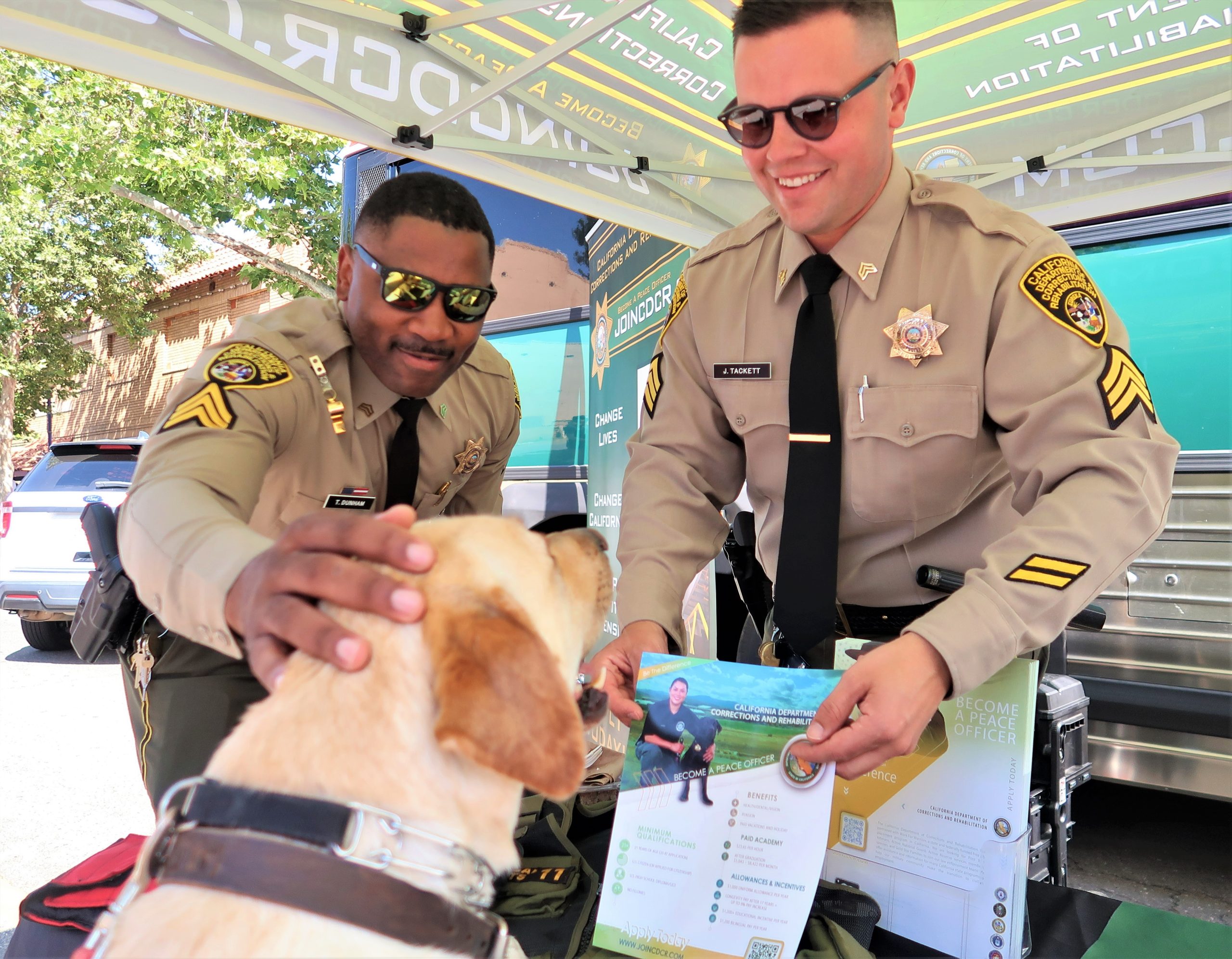 Two CDCR correctional sergeants and a dog at a market and safety event in Galt.