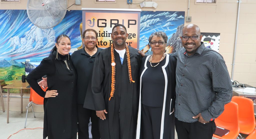 Family posing with an incarcerated graduate.