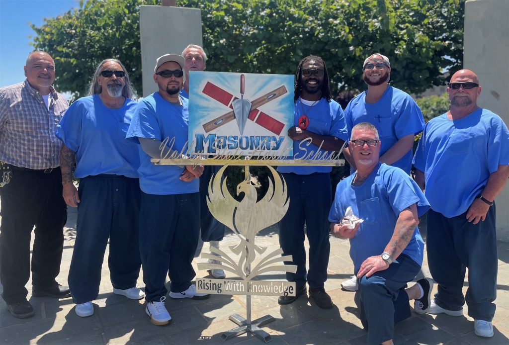 group of men standing with phoenix sign VSP education graduation