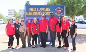 Prison staff and a school sign.