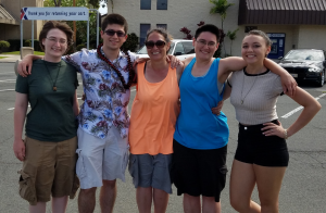 Five people standing together posing for a photo Malisa Warner Pride