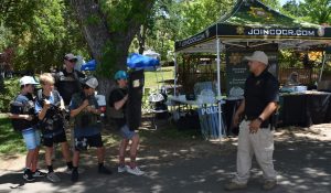 Children try on CDCR gear with recruiters at the county fair.
