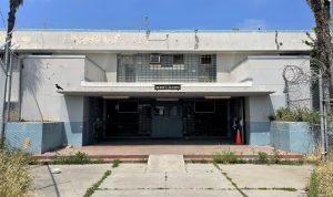 A building with the words West Dorm and Out of Bounds written across the entryway.