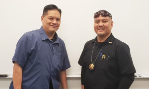 Two parole agents standing in front of a white board.