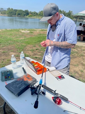 MCRP member fixing his fishing pole at Dat at the Park