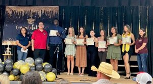 Ironwood prison staff and students holding certificates.