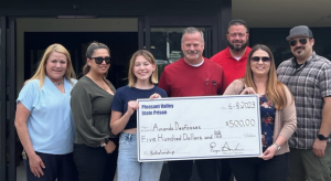 college student accepts PVSP scholarships with family and staff