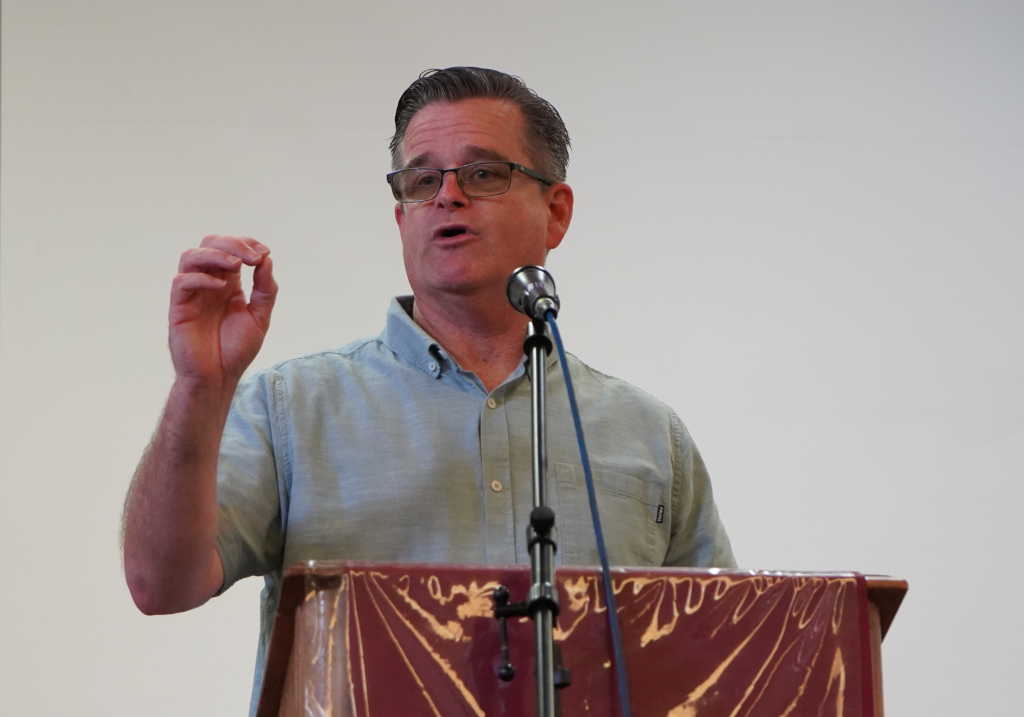 SQ warden standing in front of podium and microphone