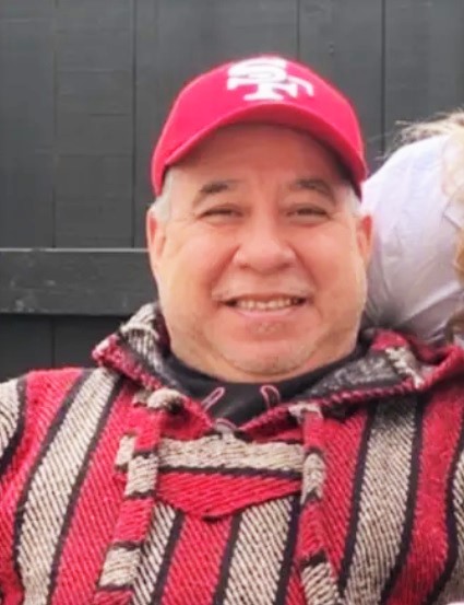 Karl Valdez wearing a hat and sweater.
