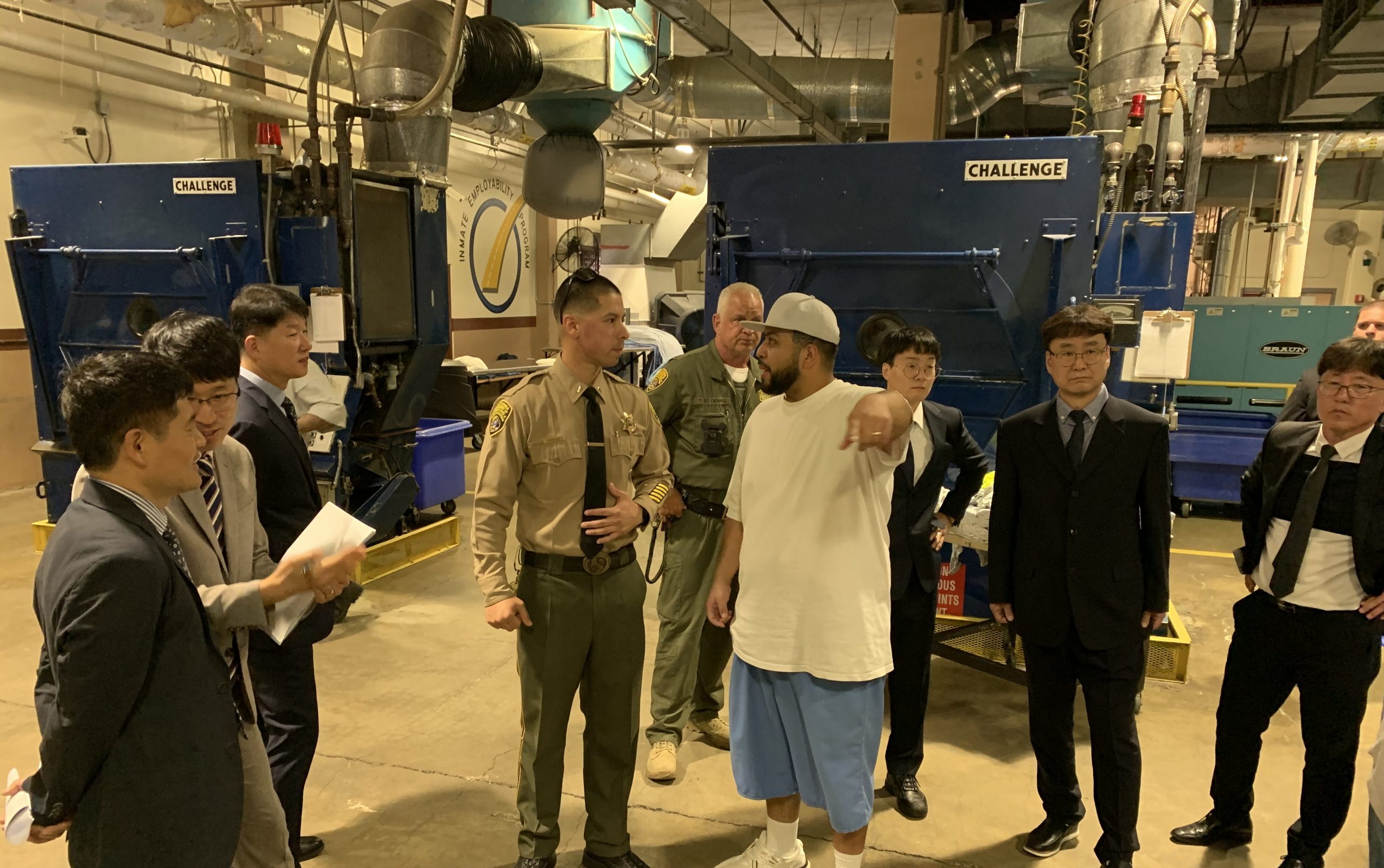 South Korea visits SAC group of men standing together in laundry facility