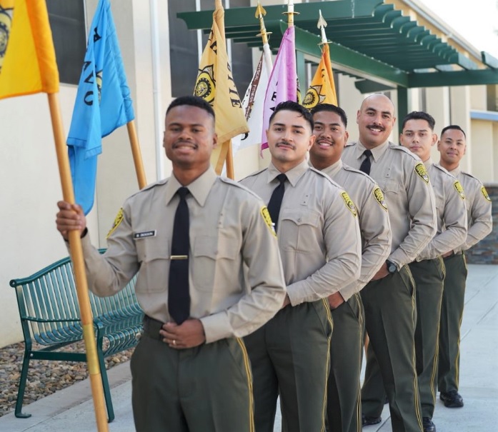 Cadets carry company flags at the Basic Correctional Officer Academy.