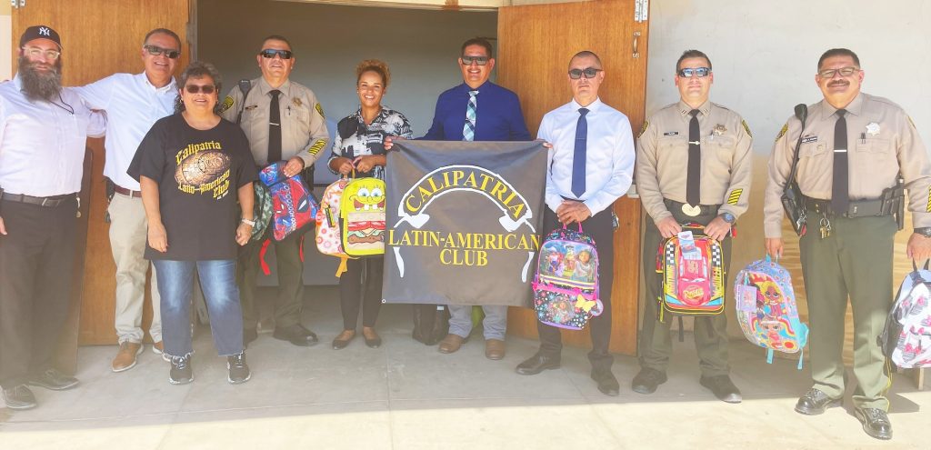 Calipatria prison staff donating backpacks and school supplies to a local school district organized by the Latin American Club.