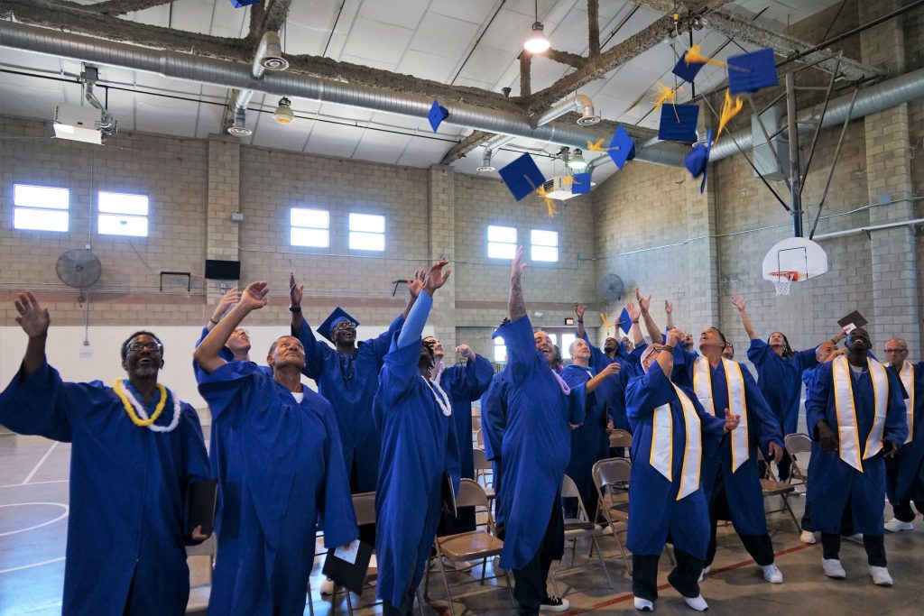 graduates throwing their caps in the air VSP Defy