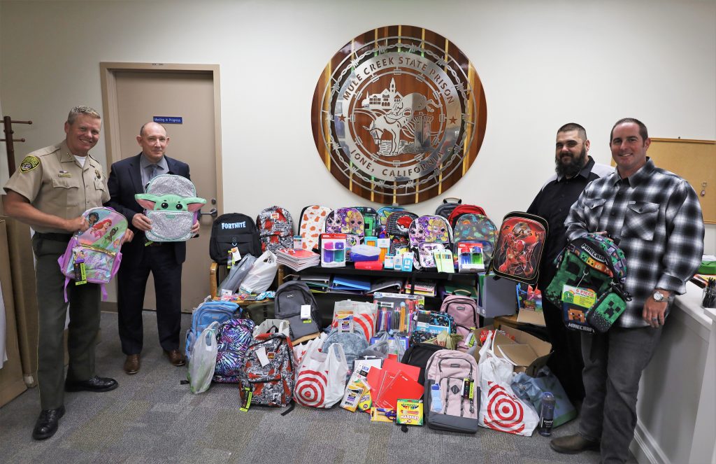 Mule Creek prison with a pile of backpacks.
