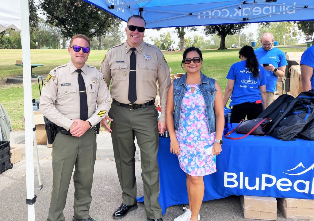 CDCR staff with backpacks at a distribution event with BluePeak Credit Union.