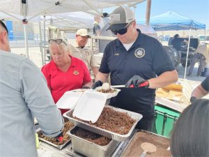 Two wardens serve food during RJD Staff Appreciation Day.