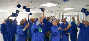 SVSP entrepreneurs-in-training graduates toss their hats in the air.