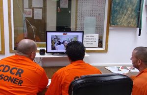 Three conservation camp students take a video GED class.