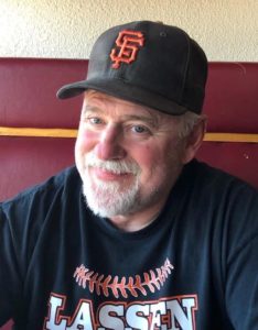 Bobby Ormachea wearing a sports shirt with the word "Lassen" across the front and a SF Giants baseball cap.