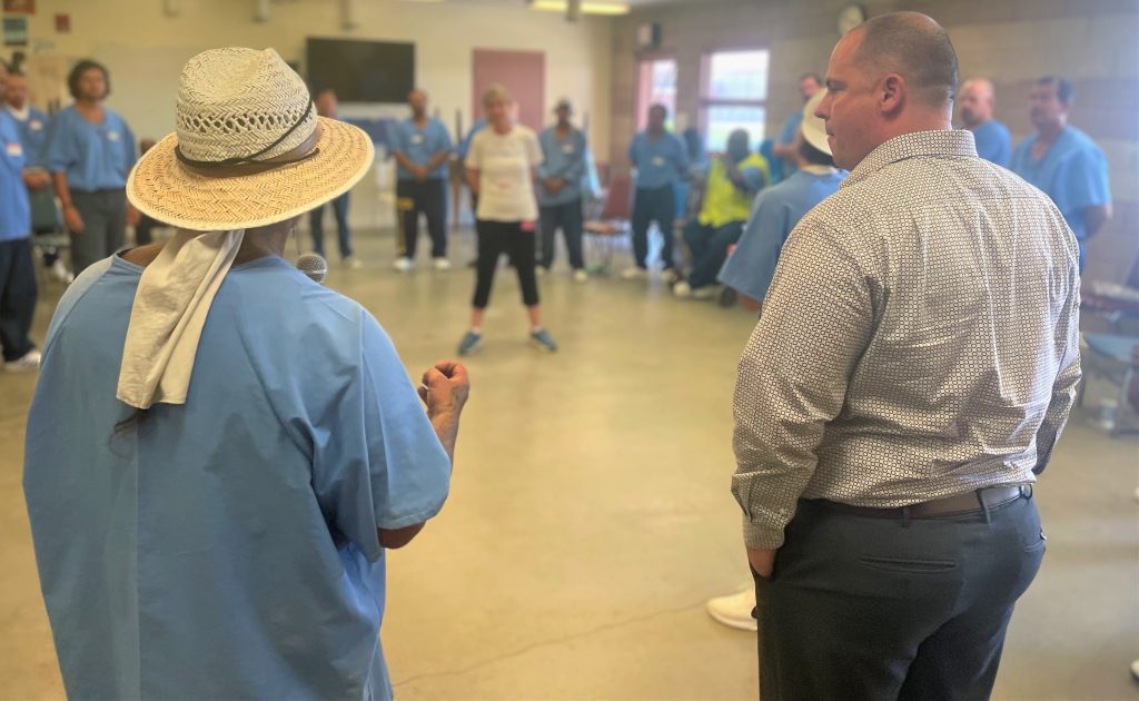 Warden McVay speaks with incarcerated during VSP Compassion Prison Project