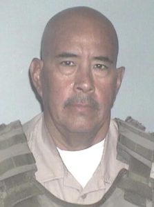 David Flores wearing a correctional officer uniform.