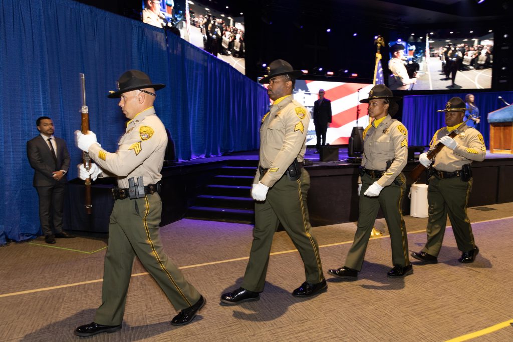 CDCR honor guard marching in front of stage.