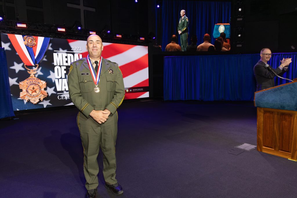 CDCR lieutenant on a stage with the medal of valor.