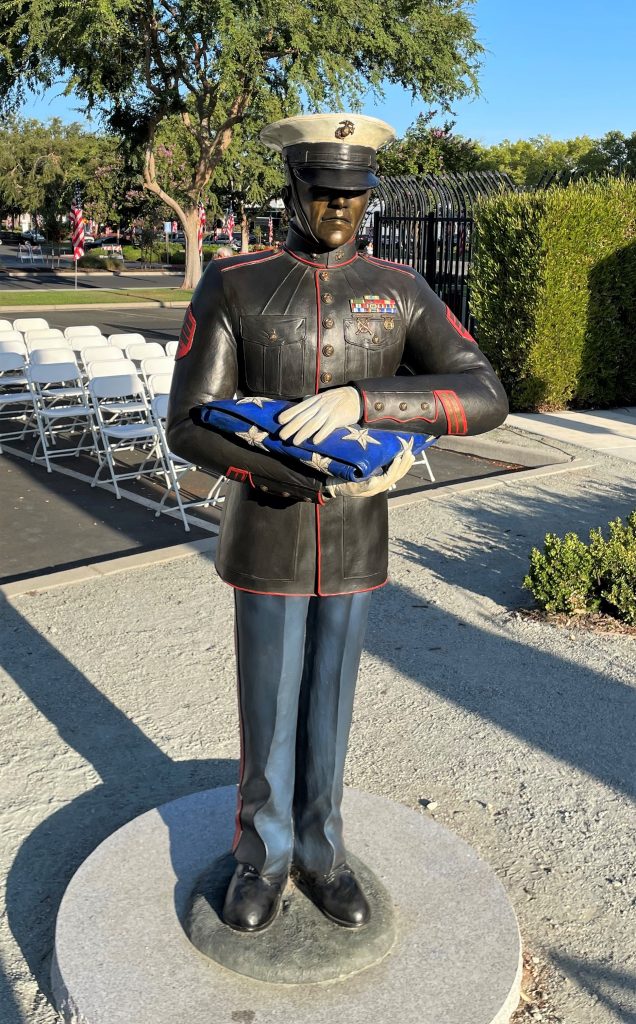 Statue of US Marine holding flag.